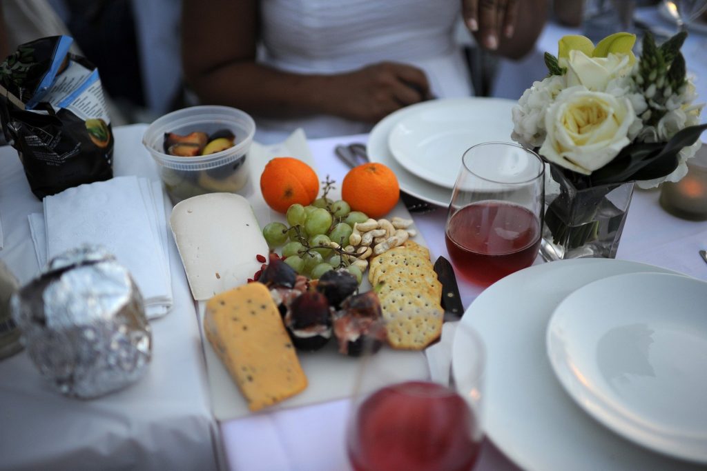 A plate cheese, fruit and nuts is brought by a guest attend the "Diner En Blanc" held at Rockefeller Park in Battery Park City in New York, NY, on August 25, 2014. The annual event is the worlds only viral culinary event, a chic secret pop-up style picnic imported from France, where guests are only told of the location at the last minute and are required to dress entirely in elegant white, bring a picnic basket of food, fine china and silverware, white tablecloths, table and chairs., Image: 202812131, License: Rights-managed, Restrictions: , Model Release: no, Credit line: Profimedia, SIPA USA