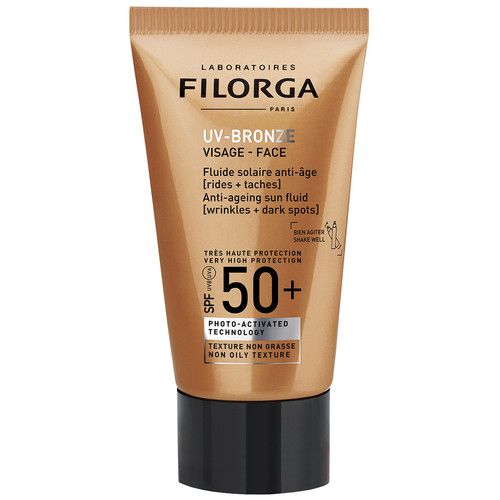  Filorga UV-Bronze Face SPF 50+ anti-aging fluid za zaštitu od sunca istovremeno se bori protiv bora i hiperpigmentacija. Sadrži moćne antioksidanse koji štite kožu i ublažavaju znakove starenja. Ovaj fluid obogaćen vitaminima ujednačava ten, čineći ga baršunastim i zaglađenim, a nemasna i brzoupijajuća tekstura ostavlja mat završetak na koži. 