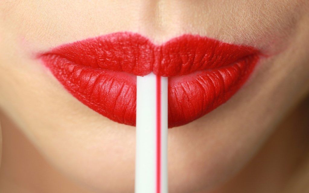 WD 1797-15 FOR EDITORIAL USE ONLY. Christian Dior. Backstage Paris Ready to wear. Spring/Summer 2010. Close up of model's mouth, wearing bright red lipstick, holding a straw between her lips. ADDITIONAL IMAGES AVAILABLE ON REQUEST. ., Image: 221729921, License: Rights-managed, Restrictions: FOR EDITORIAL USE ONLY. ADDITIONAL IMAGES AVAILABLE ON REQUEST., Model Release: no, Credit line: Profimedia, TEMP Camerapress