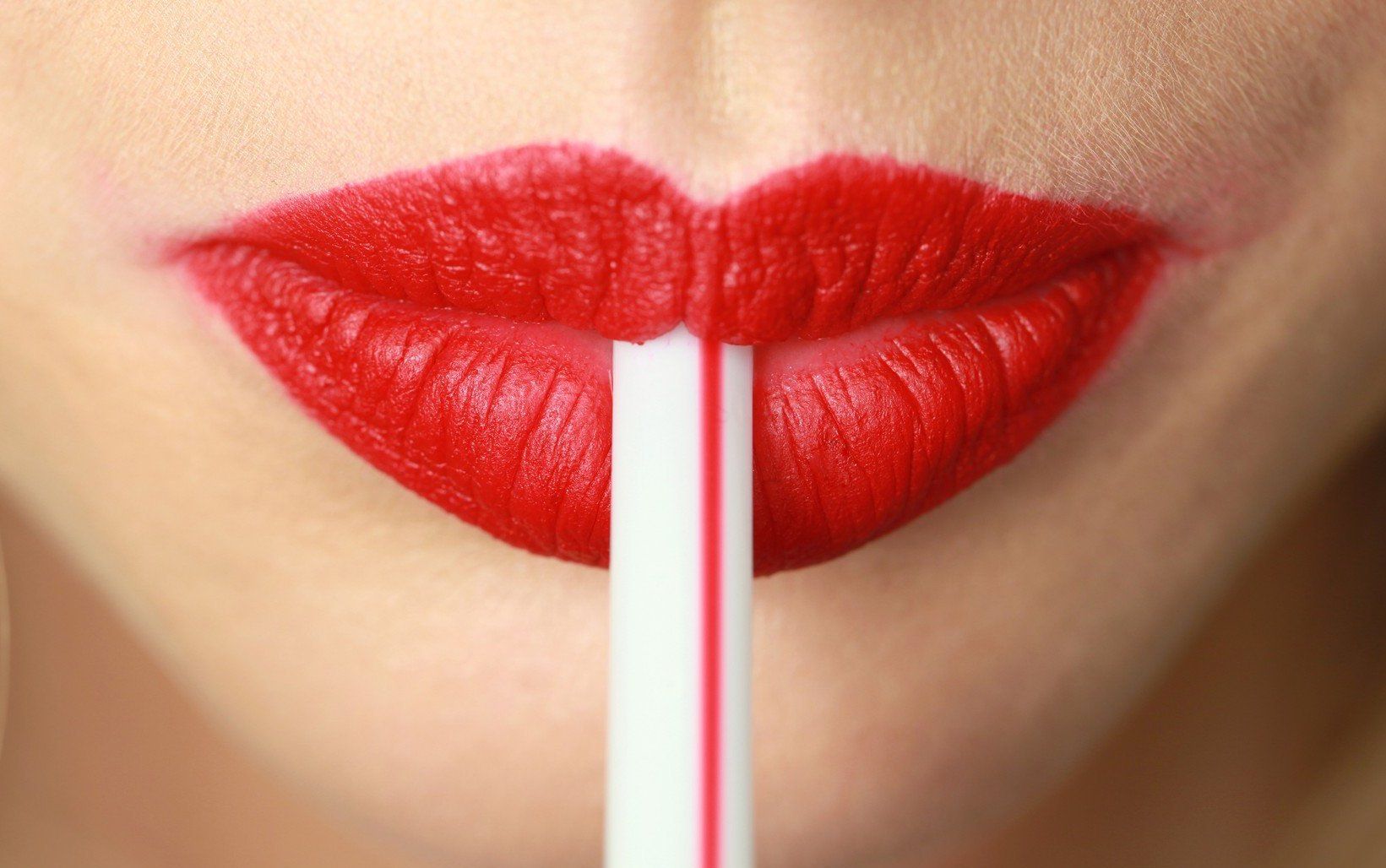 WD 1797-15 FOR EDITORIAL USE ONLY. Christian Dior. Backstage Paris Ready to wear. Spring/Summer 2010. Close up of model's mouth, wearing bright red lipstick, holding a straw between her lips. ADDITIONAL IMAGES AVAILABLE ON REQUEST. ., Image: 221729921, License: Rights-managed, Restrictions: FOR EDITORIAL USE ONLY. ADDITIONAL IMAGES AVAILABLE ON REQUEST., Model Release: no, Credit line: Profimedia, TEMP Camerapress