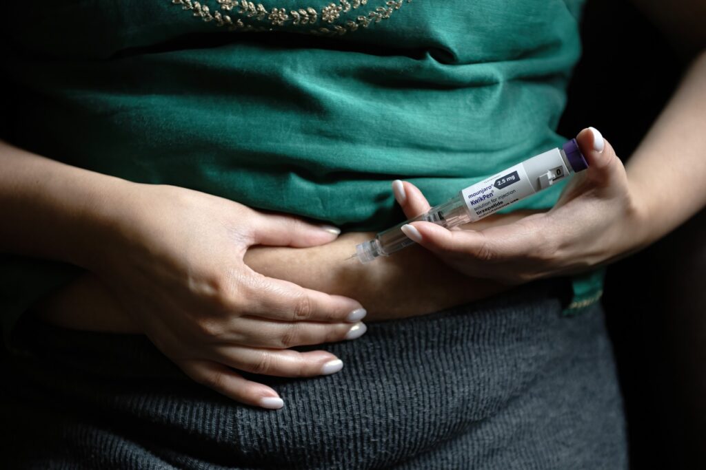 Žena si daje injekciju mounjara